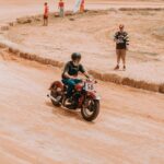 Klasyczny motocyklista pędzi po torze ziemnym podczas wyścigu